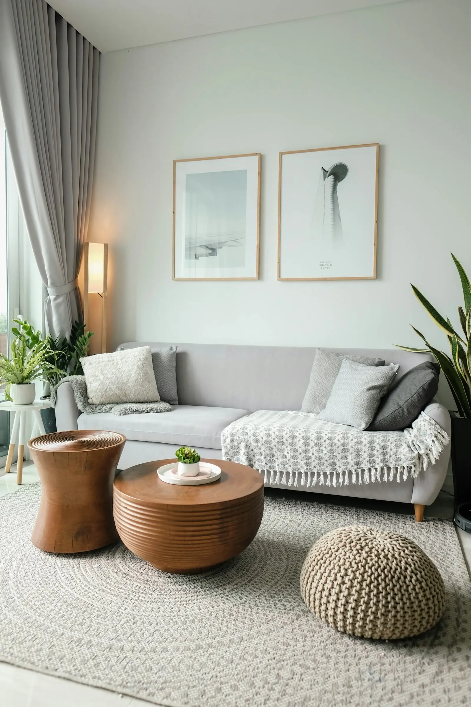 Calm sage-green living room with a linen sofa, framed art and soft daylight, an example of a resolved interior design scheme.